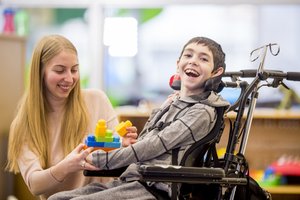 happy little boy playing with toys